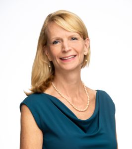 Closeup of person in a blue dress.